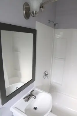 a white bathroom with a sink and a mirror at Walkerton Inn Motel in Walkerton