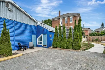 a blue building with a bench in a driveway at The Bloomfield Inn in Bloomfield