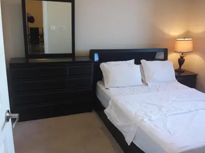 a bedroom with a bed with a mirror and a dresser at SPECTACULAR VIEW, 2 BEDROOMS FURNISHED CONDO and BEST LOCATION in Mississauga
