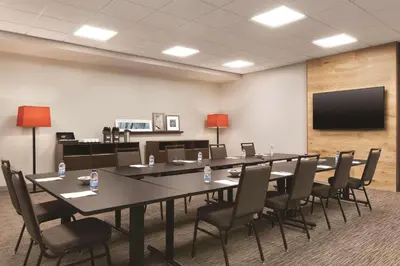 a conference room with a long table and chairs at Country Inn & Suites by Radisson, Belleville, ON in Belleville