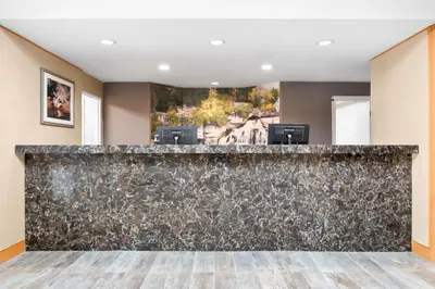 a bar in a lobby with a stone wall at Best Western Inn On The Bay in Owen Sound