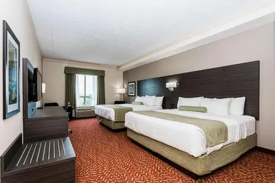 a hotel room with two beds and a television at Best Western Inn On The Bay in Owen Sound