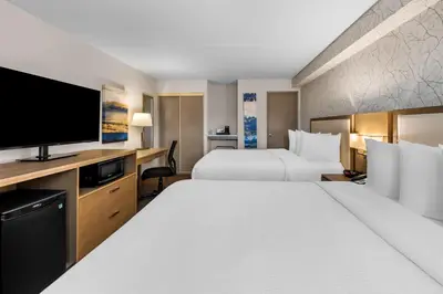 a hotel room with two beds and a flat screen tv at Best Western Halton Hills in Georgetown