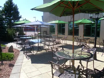 a group of tables and chairs with umbrellas at The Casablanca Hotel in Grimsby