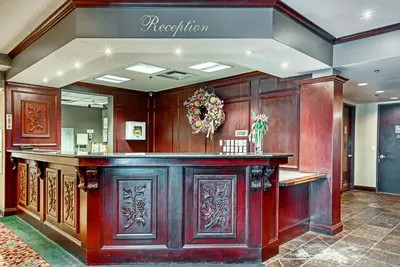 a lobby with a wooden bar in a building at The Casablanca Hotel in Grimsby