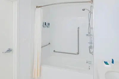 a shower with a glass door in a bathroom at Four Points by Sheraton Cambridge Kitchener, Ontario in Cambridge