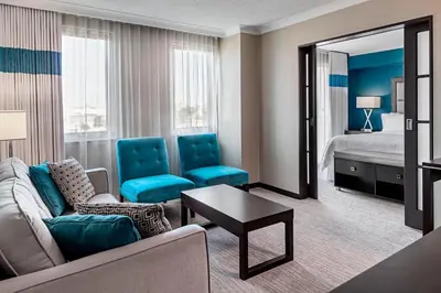 a living room with a couch and a room with a bed at Four Points by Sheraton London in London