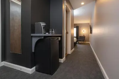 a hallway of a hotel room with a television at Jordan House Hotel in Jordan