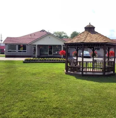 a gazebo in a yard in front of a house at Majers Motel in Stratford