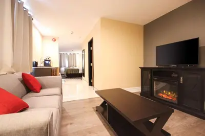 a living room with a couch and a fireplace at Quality Inn in Bracebridge