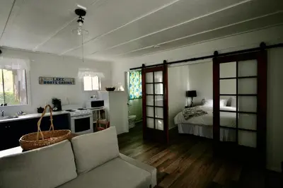 a living room with a bed and a couch at Beachside on Lake Muskoka in Port Carling