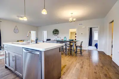 a kitchen and living room with a sink and a table at GlobalStay Modern House near Huron Lake Port Elgin in Port Elgin