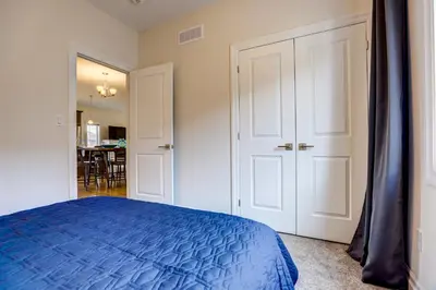 a bedroom with a blue bed and a dining room at GlobalStay Modern House near Huron Lake Port Elgin in Port Elgin