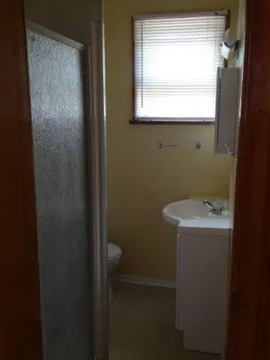 a bathroom with a sink and a toilet and a window at Sunrise Resort in Buckhorn