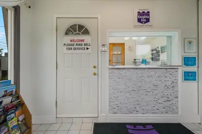 a door in a store with a sign on it at Knights Inn Burlington in Burlington