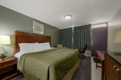 a hotel room with a bed and a desk at Knights Inn Burlington in Burlington