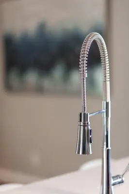 a kitchen sink with a chrome kitchen faucet at ENTIRE 2 BEDROOM APARTMENT UPTOWN WATERLOO - e3 in Waterloo