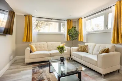 a living room with two couches and a table at ENTIRE 2 BEDROOM APARTMENT DOWNTOWN - u1 in Kitchener