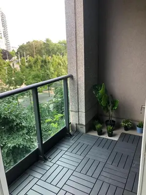 a balcony with potted plants on a building at Executive 1 Bedroom Condo sleeps 2 in Toronto