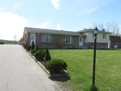 a house with a street light in the grass at Newburg Inn Motel in New Hamburg