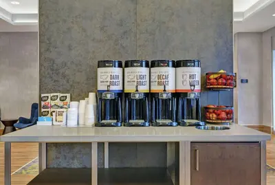 a table with a bunch of cans on top of it at Hampton Inn Peterborough in Peterborough