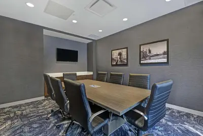 a conference room with a wooden table and chairs at Hampton Inn Peterborough in Peterborough