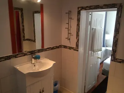 a bathroom with a sink and a mirror at Keppner Guesthouse in Toronto