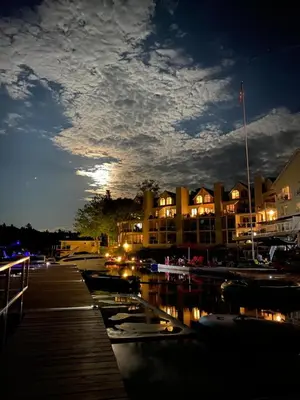 a group of boats docked in a marina at night at Muskoka Lakes Hotel and Resorts in Port Carling
