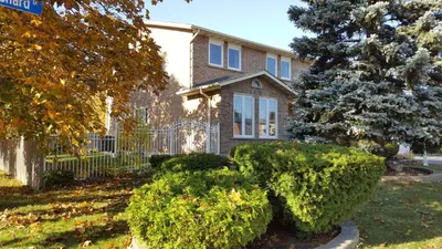 a house with bushes in front of it at Comfort Stays near Toronto Airport in Mississauga