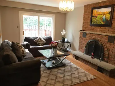 a living room with a couch and a fireplace at Comfort Stays near Toronto Airport in Mississauga