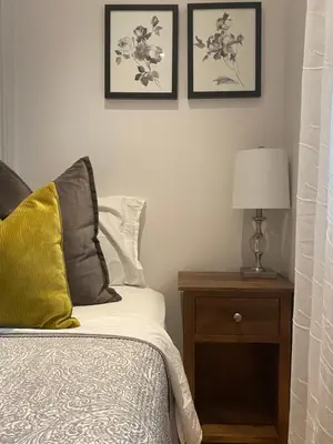 a bedroom with a bed and a table with a lamp at Clearbrooke Gem- Bright Private Bedroom close to YYZ in Toronto