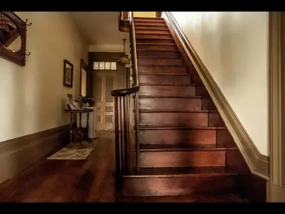 a wooden staircase in a home with a wooden floor at Culverdene House in Simcoe