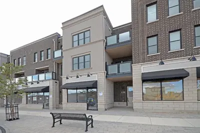a bench sitting in front of a building at Royal Stays Townhome Collection - 3 Bedroom Townhome in Oakville in Oakville