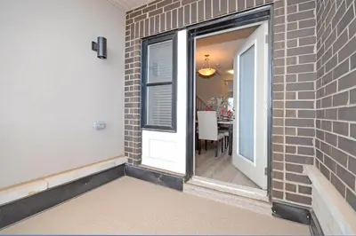 a brick wall with a door and a dining room at Royal Stays Townhome Collection - 3 Bedroom Townhome in Oakville in Oakville