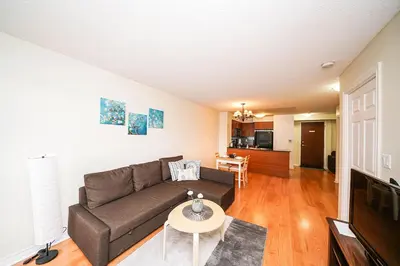 a living room with a couch and a table at PlanURstay - Luxury Suites Mississauga Downtown in Mississauga