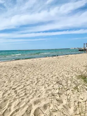 a sandy beach with the ocean in the background at Paradise Inn On the Beach in Port Elgin