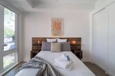 a bedroom with a bed with towels on it at Elegant Downtown Home in Toronto
