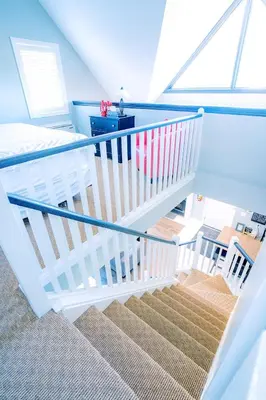 a white staircase in a room with a bed at Gorgeous Loft in the Heart of Blue Mountain in Blue Mountains