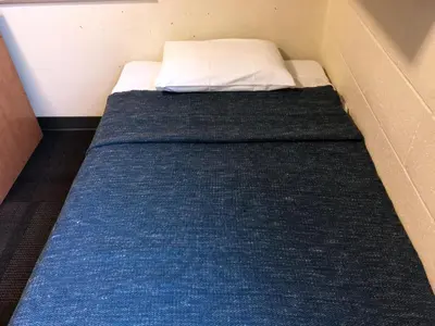 a small bed in a corner of a room at Toronto Metropolitan University- Pitman Hall Residence in Toronto
