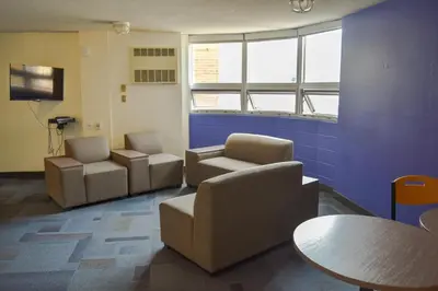 a waiting room with two chairs and a table at Toronto Metropolitan University- Pitman Hall Residence in Toronto