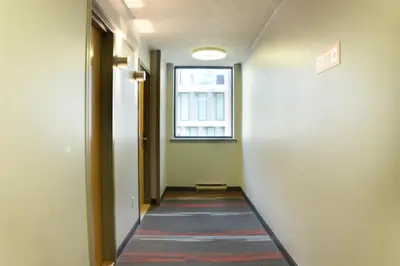 a hallway with a window and a rug on the floor at Toronto Metropolitan University-International Living Learning Residence in Toronto