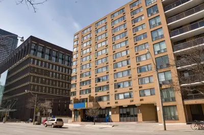 a large brick building on a city street at Toronto Metropolitan University-International Living Learning Residence in Toronto