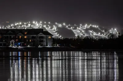 a building at night with lights on a lake at Cachet Crossing in Blue Mountains