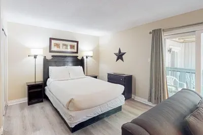 a bedroom with a bed and a couch at Condo 206 at North Creek Resort in Blue Mountains