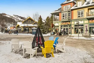 a group of chairs and a table in the snow at Condo 904 at North Creek Resort in Blue Mountains