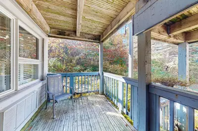 a porch with a blue chair and windows at Condo 904 at North Creek Resort in Blue Mountains