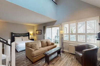 a bedroom with a bed and a couch and a chair at Condo 310 at North Creek Resort in Blue Mountains