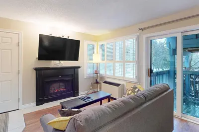 a living room with a couch and a fireplace at Condo 704 at North Creek Resort in Blue Mountains
