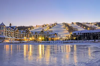 a resort in the snow with a lake and buildings at Condo 713 at North Creek Resort in Blue Mountains