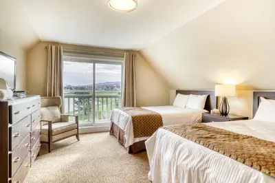 a hotel room with two beds and a window at Rivergrass 226 in Blue Mountains